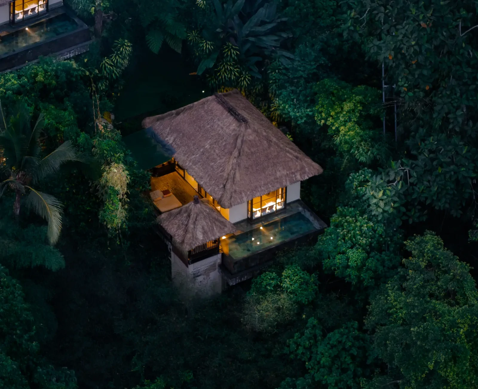 Couple relaxing in private pool villa overlooking rainforest in Bali