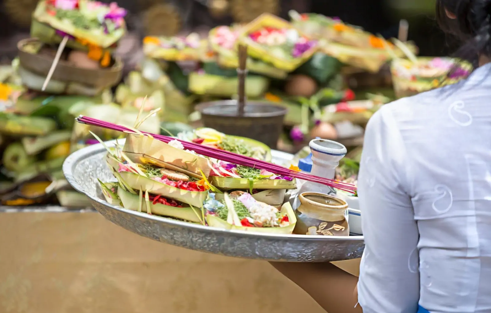 Balinese Hindu morning ritual with offerings during spiritual ceremony in Bali