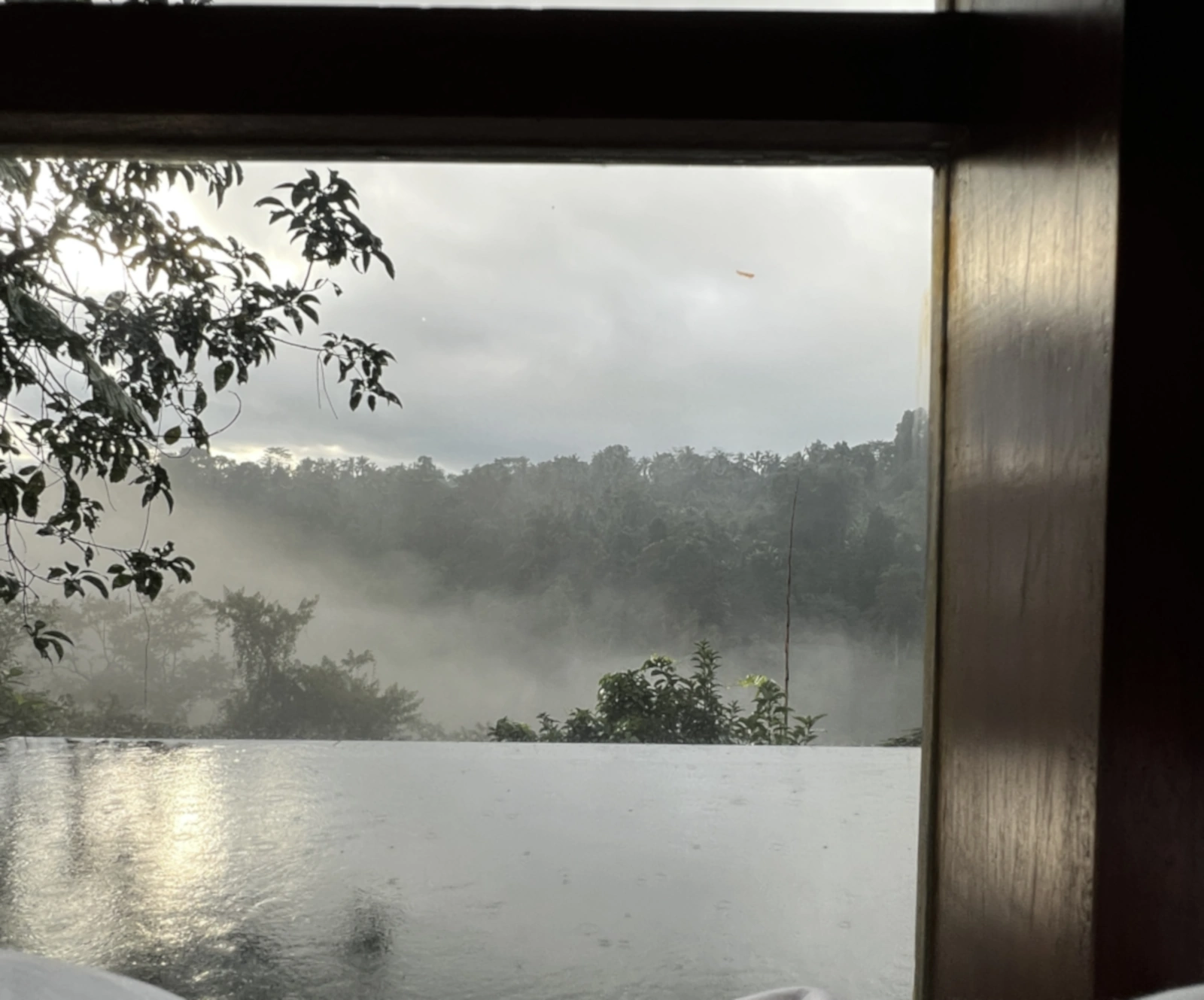 Tropical rainfall in Bali during March viewed from luxury jungle villa
