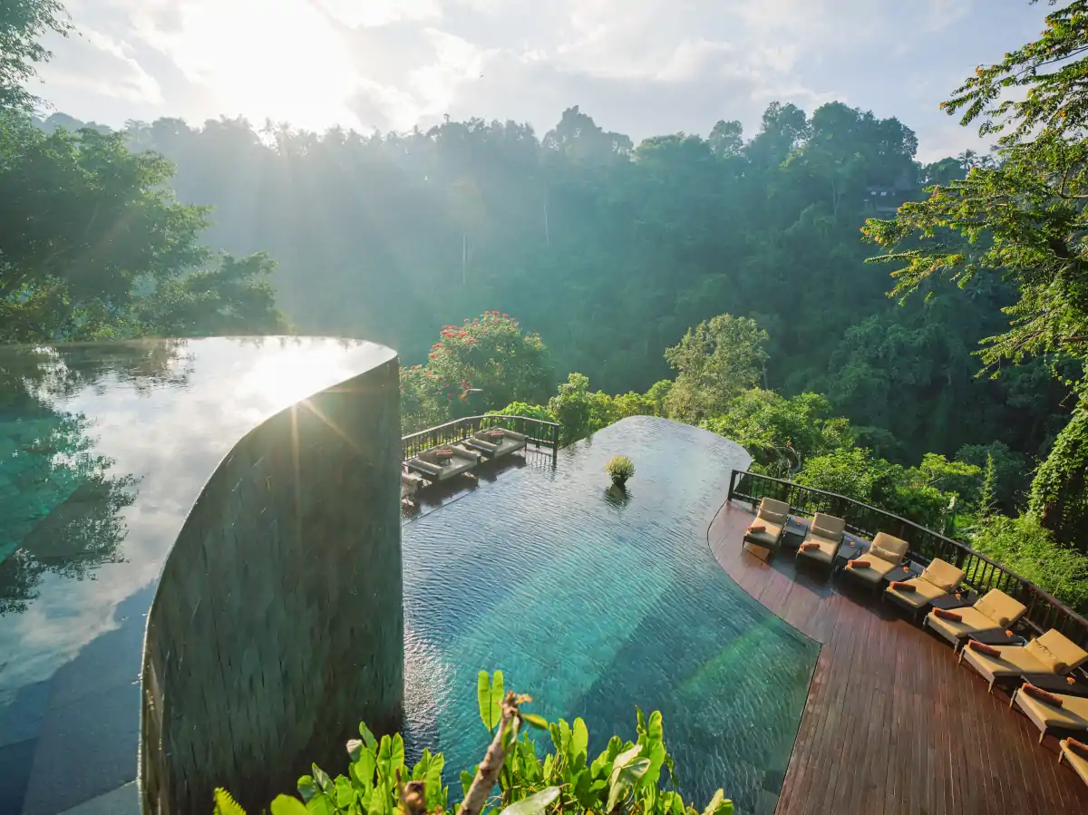 Hanging Gardens of Bali infinity pool overlooking jungle during Bali dry season June July August