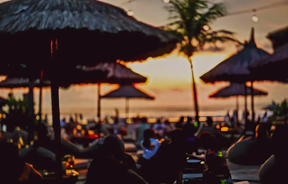 Bali in July beach club atmosphere with vibrant summer energy and peak season travel