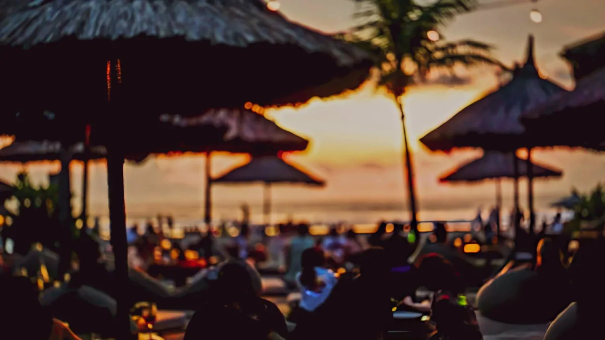 Bali beach club in peak season with vibrant crowd and sunset atmosphere in summer