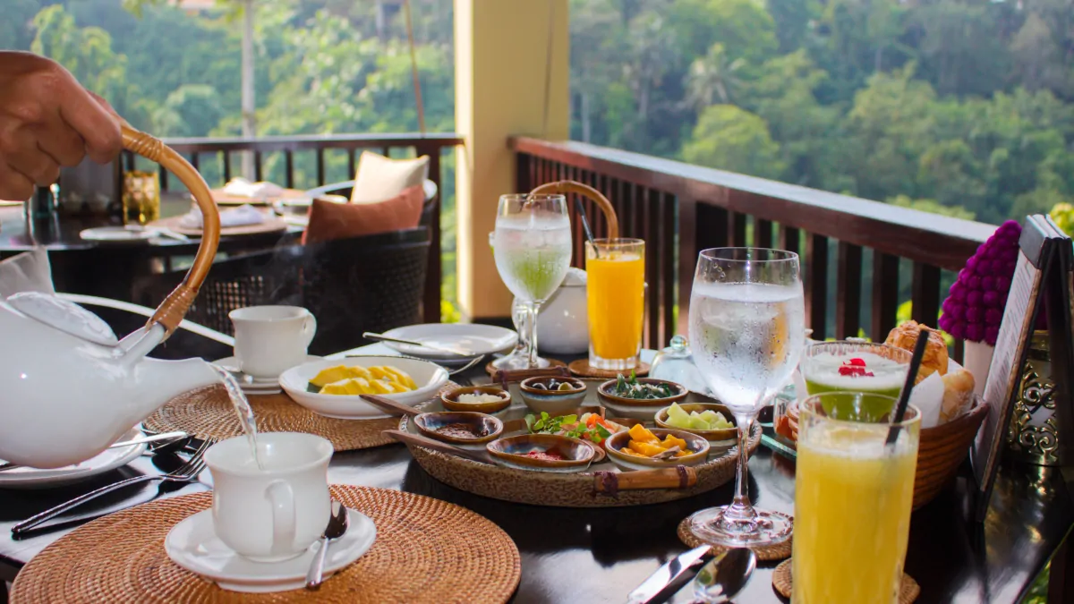 Relaxed breakfast overlooking jungle in Ubud with coffee and tropical setting