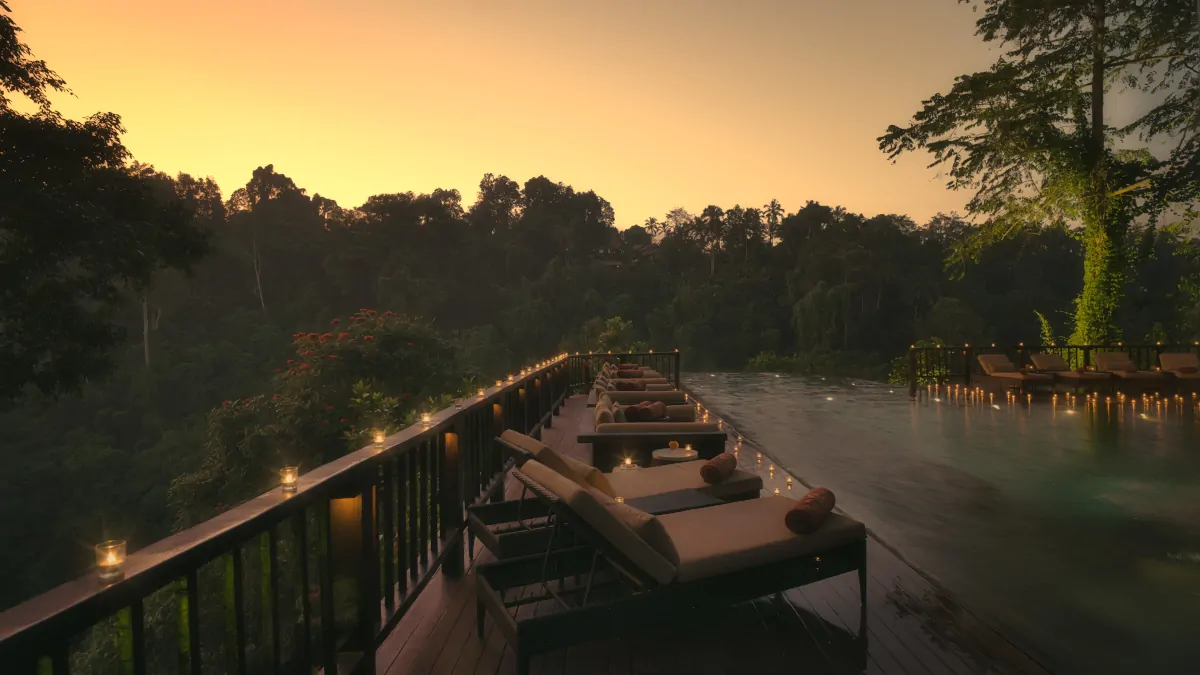 Hanging Gardens of Bali rainforest valley at sunset with warm light and peaceful atmosphere