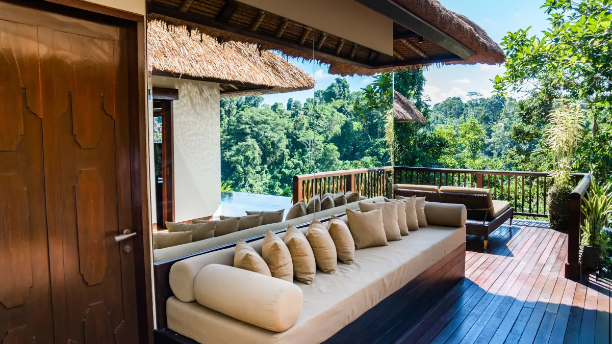 Hanging Gardens of Bali villa terrace overlooking rainforest valley with infinity pool in Ubud